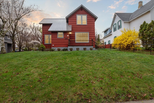 back house at dusk featuring a yard