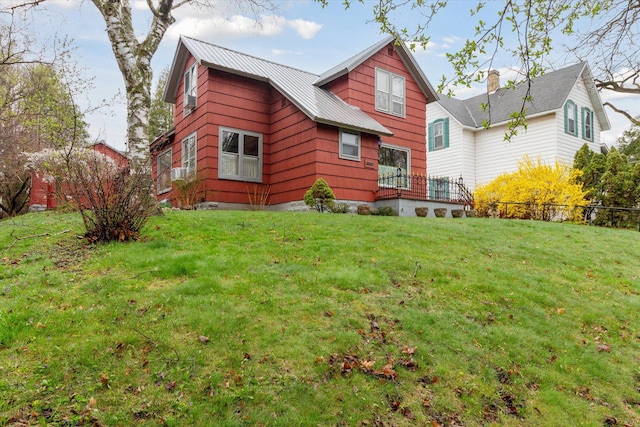 rear view of property featuring a yard