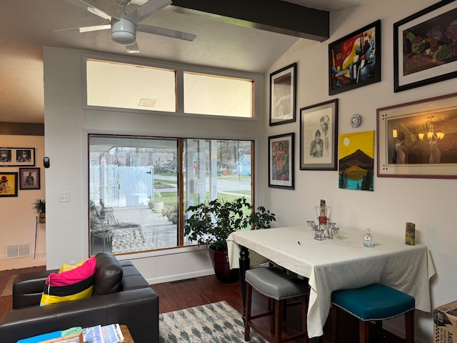 dining area featuring ceiling fan, lofted ceiling with beams, and hardwood / wood-style flooring