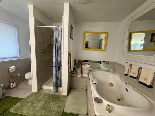 bathroom with tile flooring, tile walls, a shower with shower curtain, a textured ceiling, and toilet