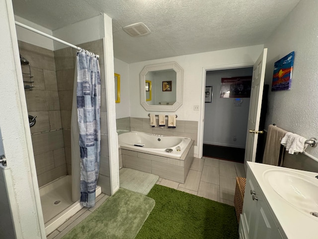 bathroom featuring tile floors, walk in shower, a textured ceiling, and vanity