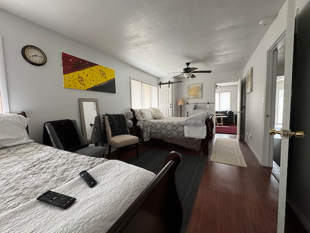 bedroom with dark hardwood / wood-style floors, ceiling fan, and multiple windows