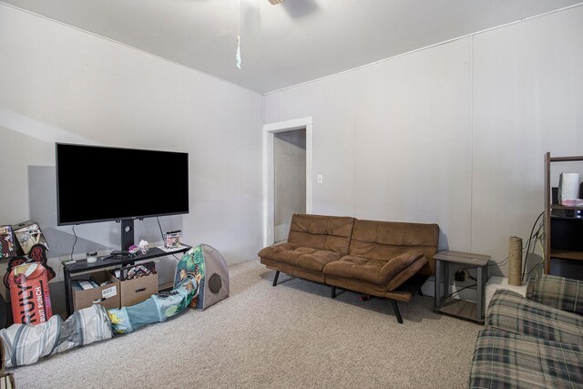 living room with ceiling fan and light colored carpet