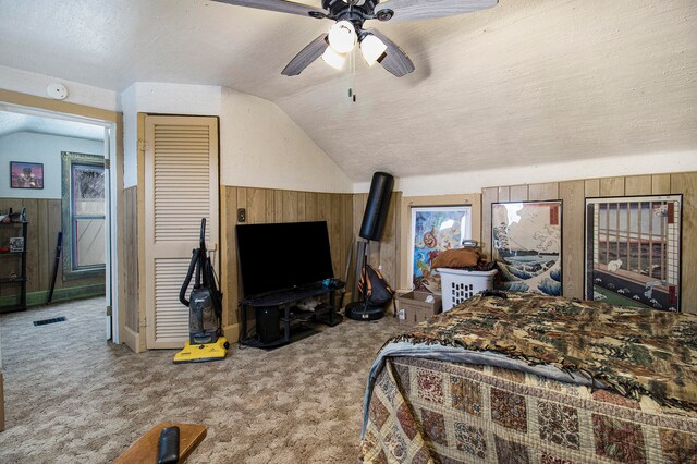 carpeted bedroom featuring a textured ceiling, ceiling fan, and lofted ceiling