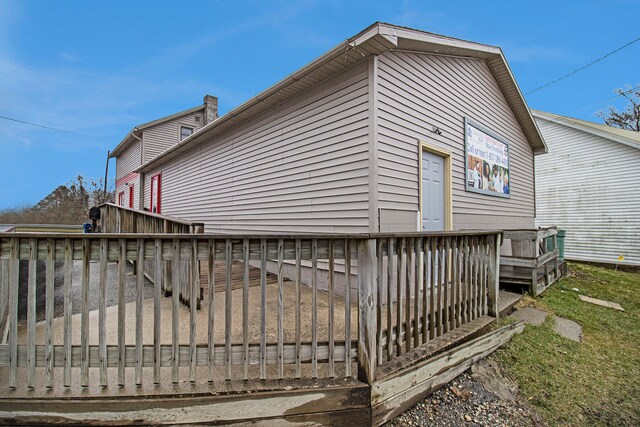 view of home's exterior with a wooden deck