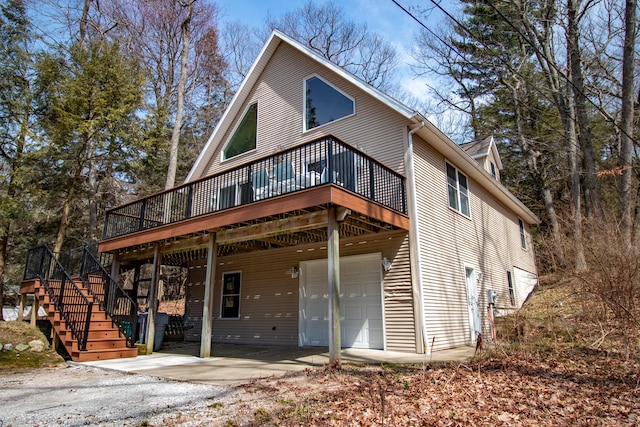 view of front of house with a wooden deck and a garage