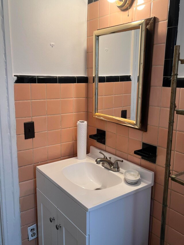 bathroom with backsplash, oversized vanity, and tile walls