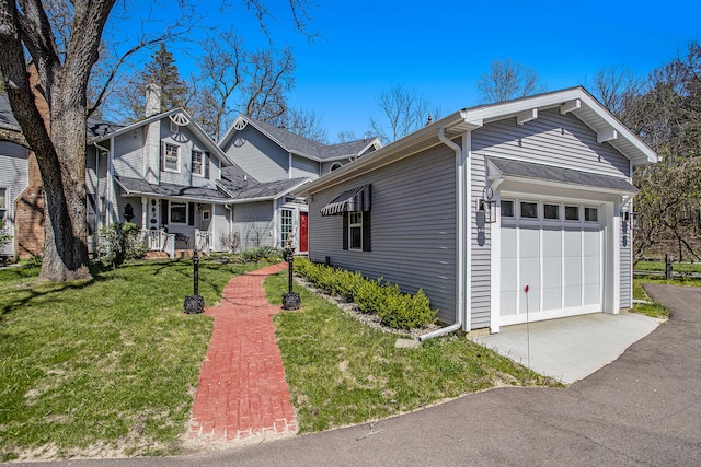 view of front of home with a garage and a front lawn