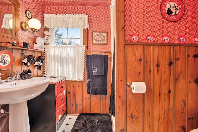 bathroom featuring wooden walls and tile patterned floors