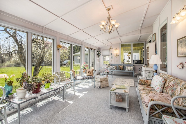 sunroom / solarium featuring lofted ceiling and an inviting chandelier