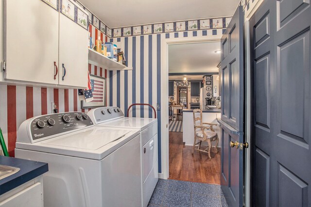 laundry room featuring cabinets, dark hardwood / wood-style flooring, and washer and dryer