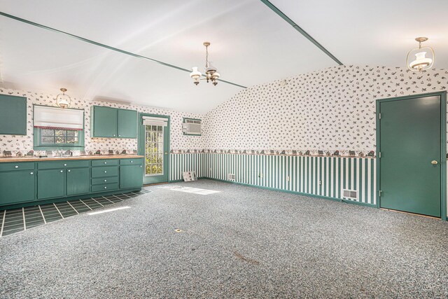 kitchen with dark tile patterned flooring, lofted ceiling, sink, ceiling fan, and green cabinetry