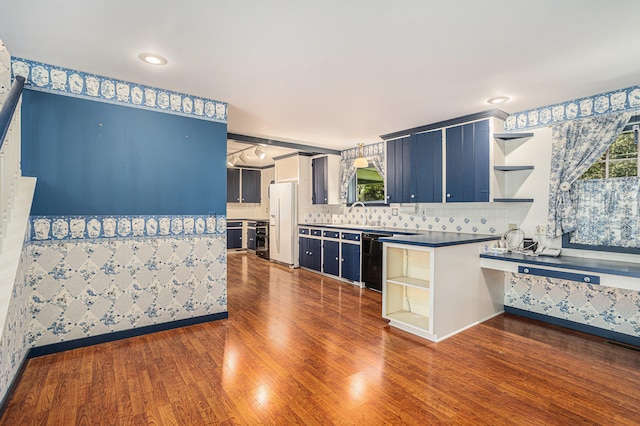 kitchen with blue cabinets and dark hardwood / wood-style flooring