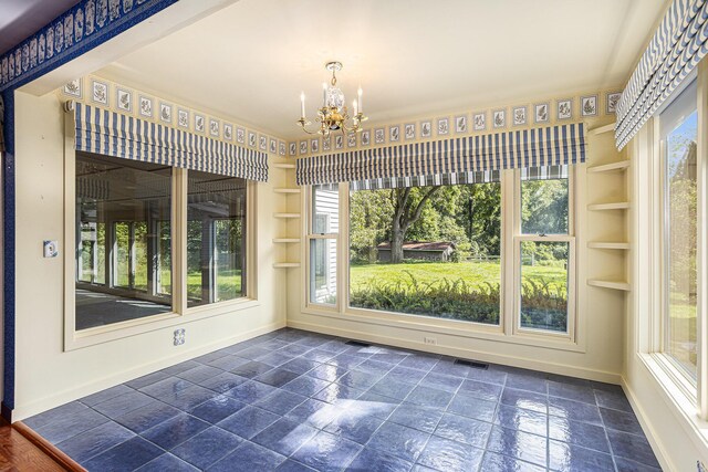 unfurnished sunroom with a notable chandelier