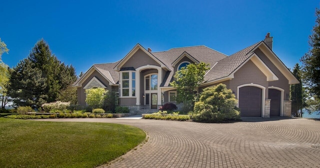 view of front of home featuring a garage and a front lawn