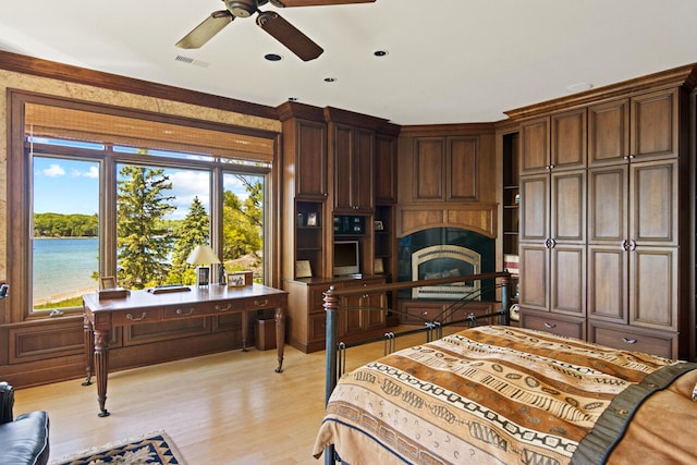 bedroom with a water view, ceiling fan, ornamental molding, and light hardwood / wood-style flooring