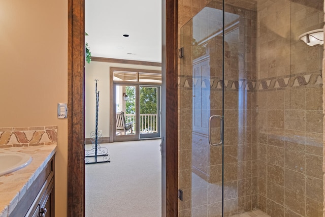 bathroom with vanity, ornamental molding, and walk in shower