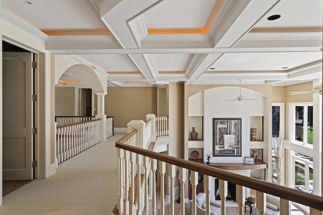 hall with coffered ceiling, ornamental molding, beamed ceiling, and carpet flooring