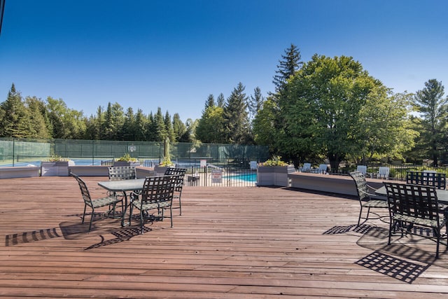 wooden deck with a community pool