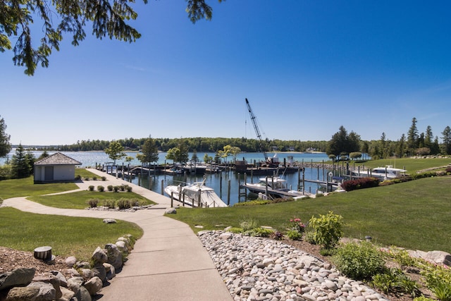 view of dock featuring a water view and a yard