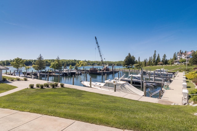 dock area with a water view and a yard