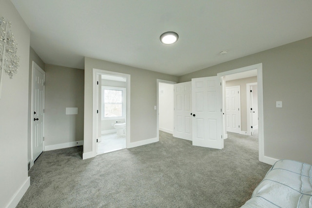 carpeted bedroom featuring ensuite bathroom