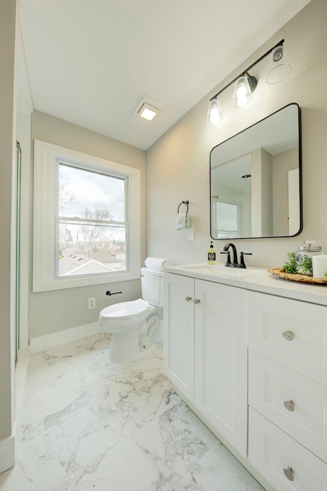 bathroom with tile floors, vanity, and toilet