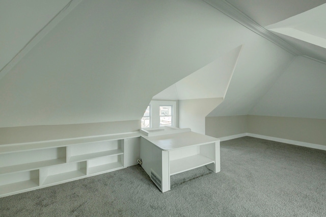 bonus room featuring vaulted ceiling and carpet flooring