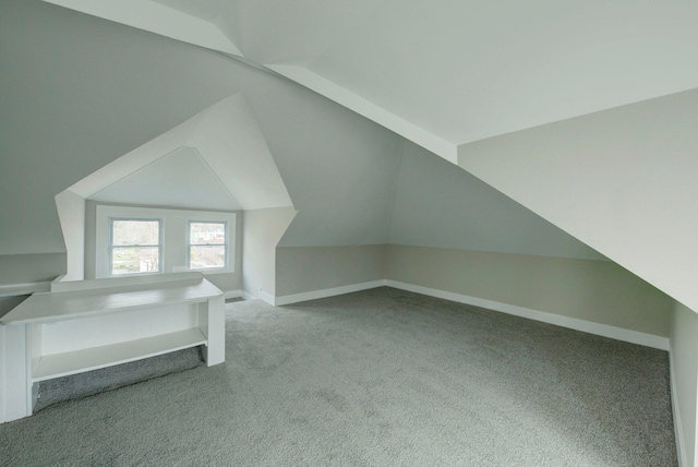 bonus room with carpet flooring and vaulted ceiling