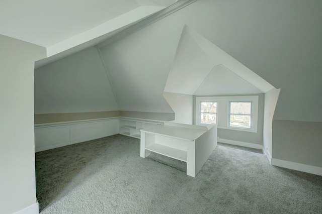 bonus room featuring vaulted ceiling and carpet flooring