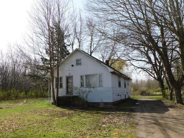 view of side of property with a lawn