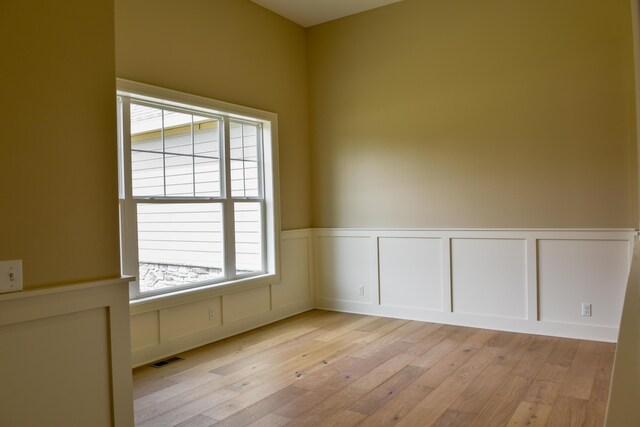 spare room featuring light hardwood / wood-style floors