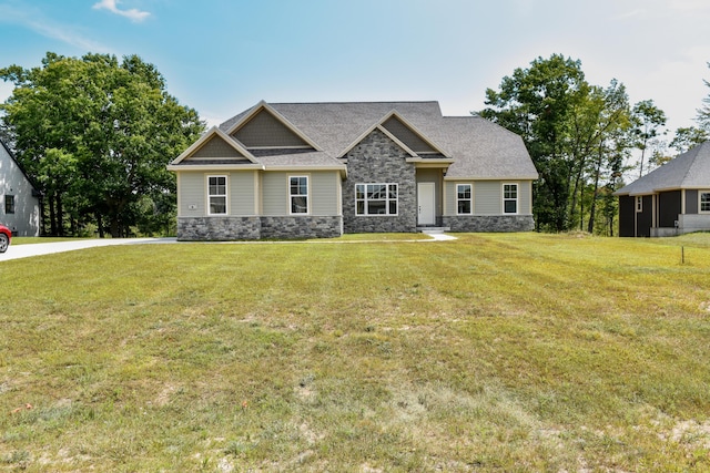 craftsman house with stone siding and a front yard