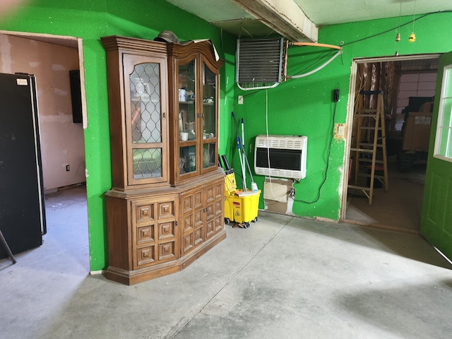 interior space with heating unit and concrete flooring