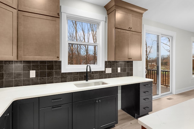 kitchen featuring sink, a healthy amount of sunlight, light brown cabinets, and light hardwood / wood-style floors