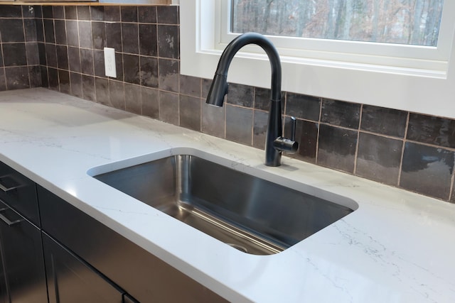 details featuring light stone counters and sink