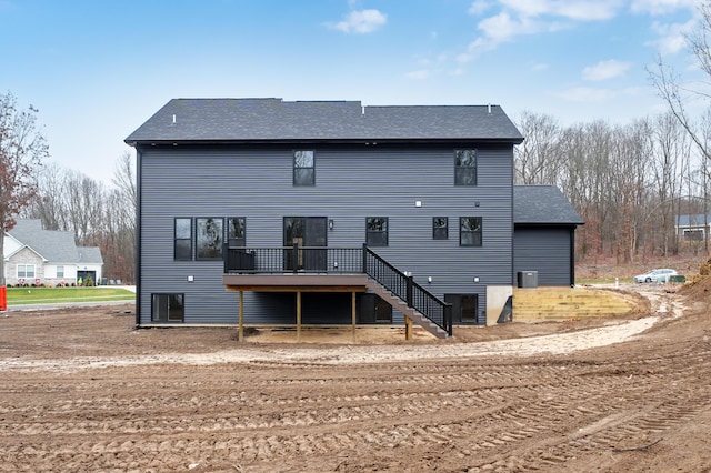 rear view of house featuring a wooden deck