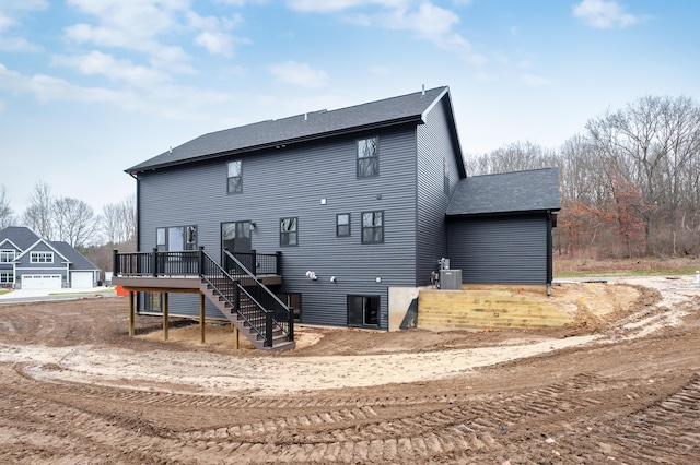 back of house featuring cooling unit and a deck