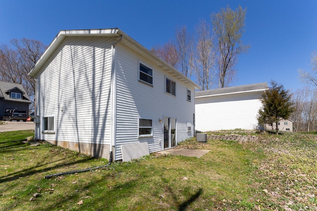 view of home's exterior featuring central AC and a yard