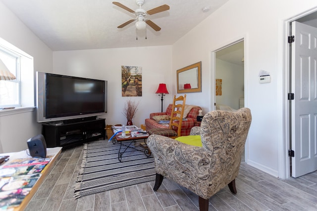 living room featuring light hardwood / wood-style floors, ceiling fan, and lofted ceiling