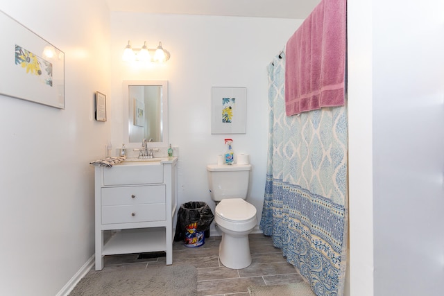 bathroom featuring vanity with extensive cabinet space, toilet, and tile floors