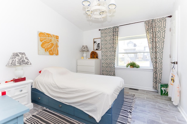 bedroom with vaulted ceiling and a chandelier