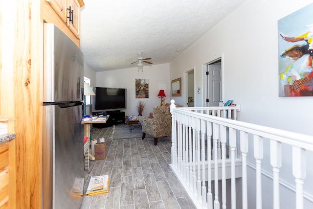 hall featuring lofted ceiling and light hardwood / wood-style flooring