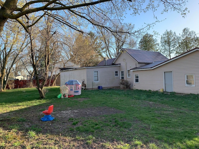 rear view of house with a yard