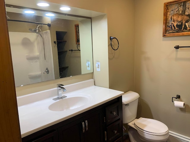 bathroom featuring baseboard heating, toilet, and large vanity