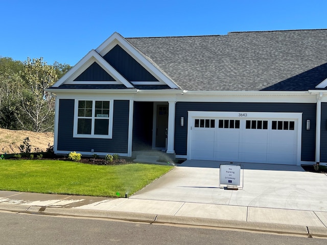 view of front of house featuring a garage and a front yard