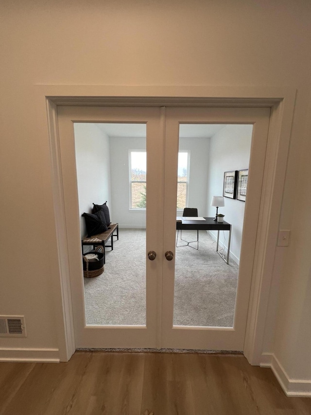 doorway to outside featuring french doors and hardwood / wood-style flooring