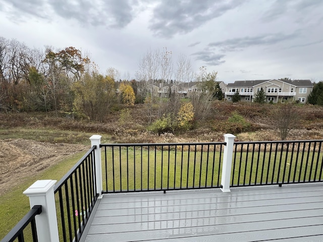 wooden deck featuring a yard