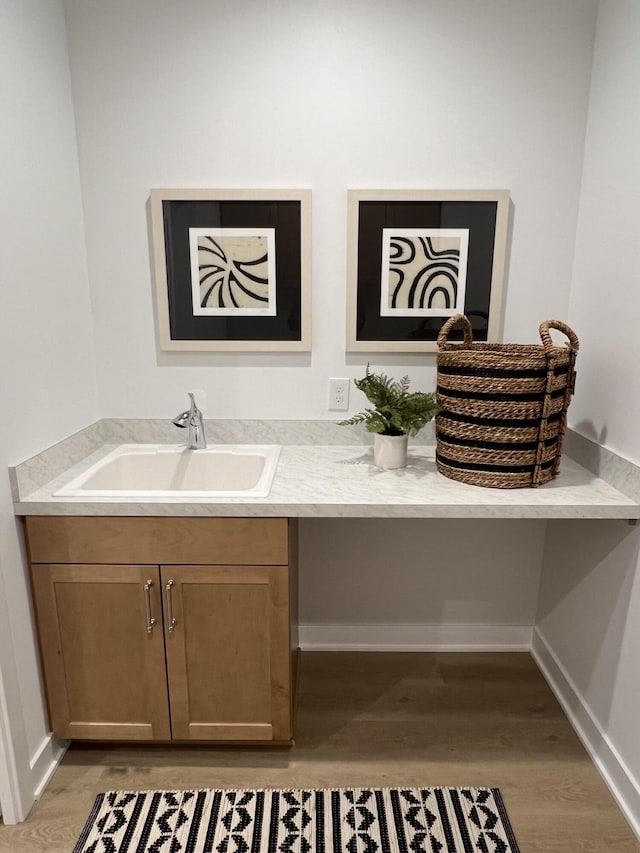 bathroom with hardwood / wood-style flooring and sink