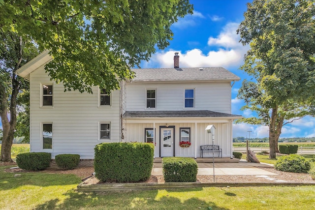 view of front of house with a porch and a front lawn